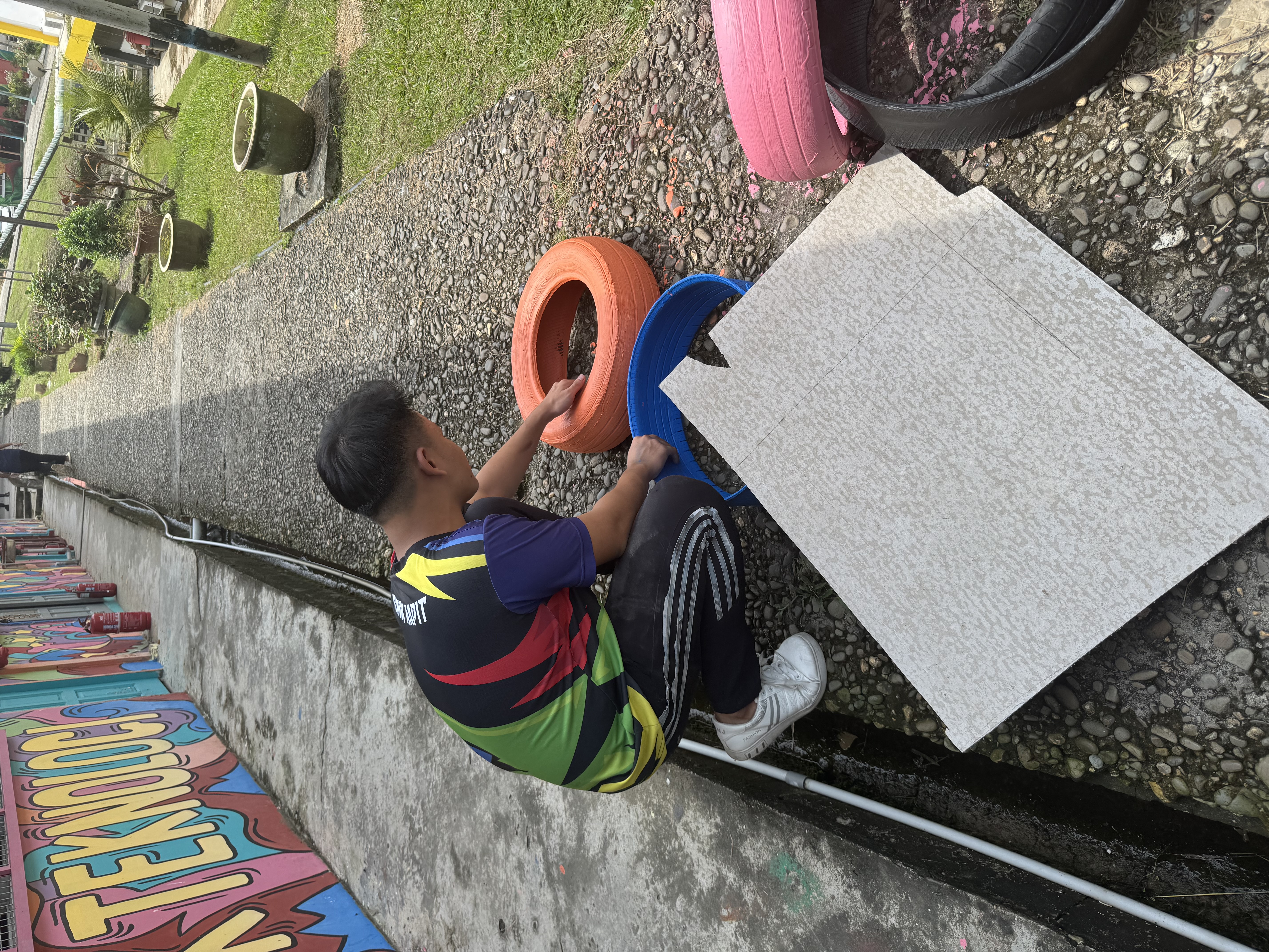 Painting the recycled tires outdoors
