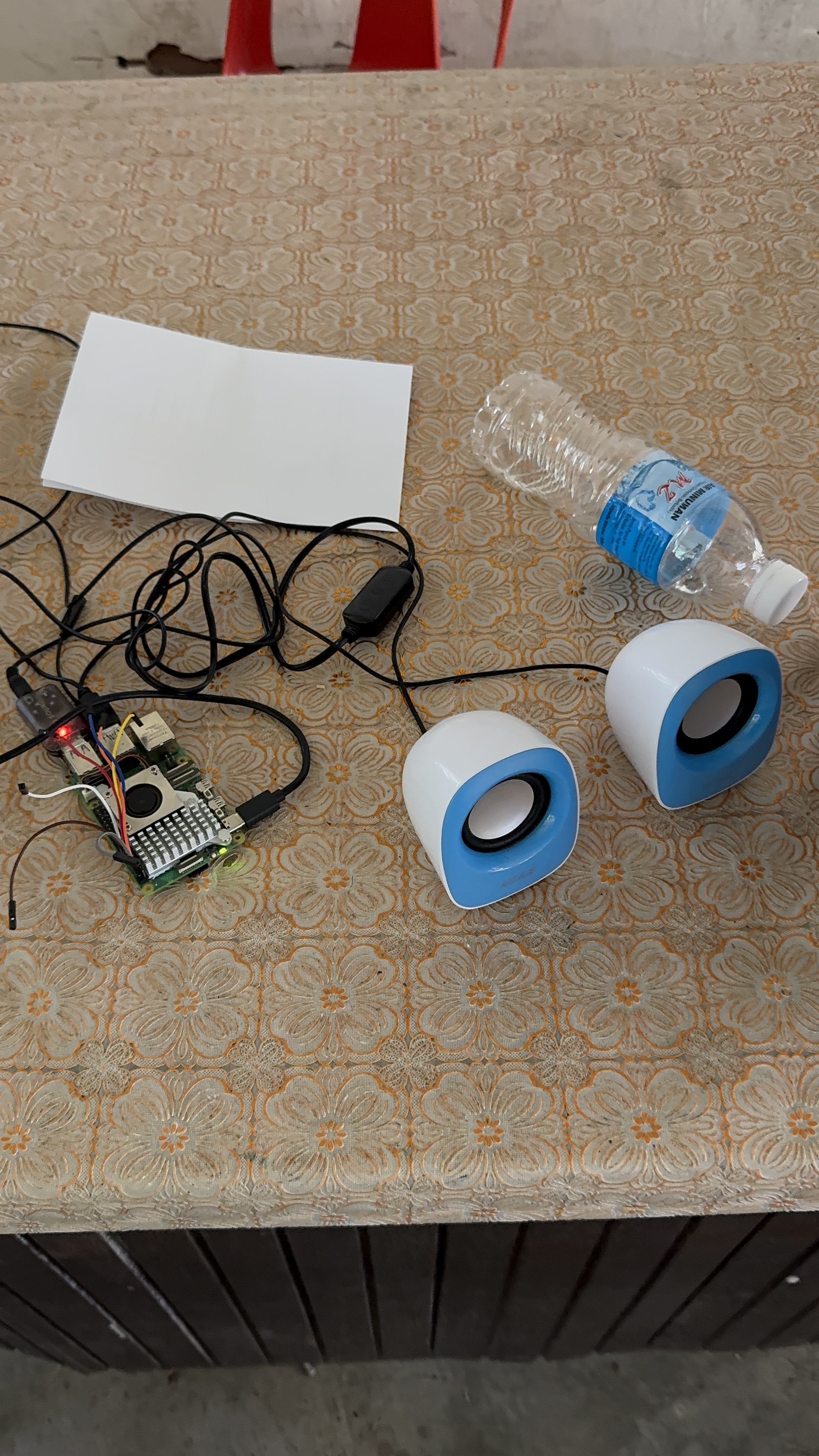 Raspberry Pi connected to speakers on a table